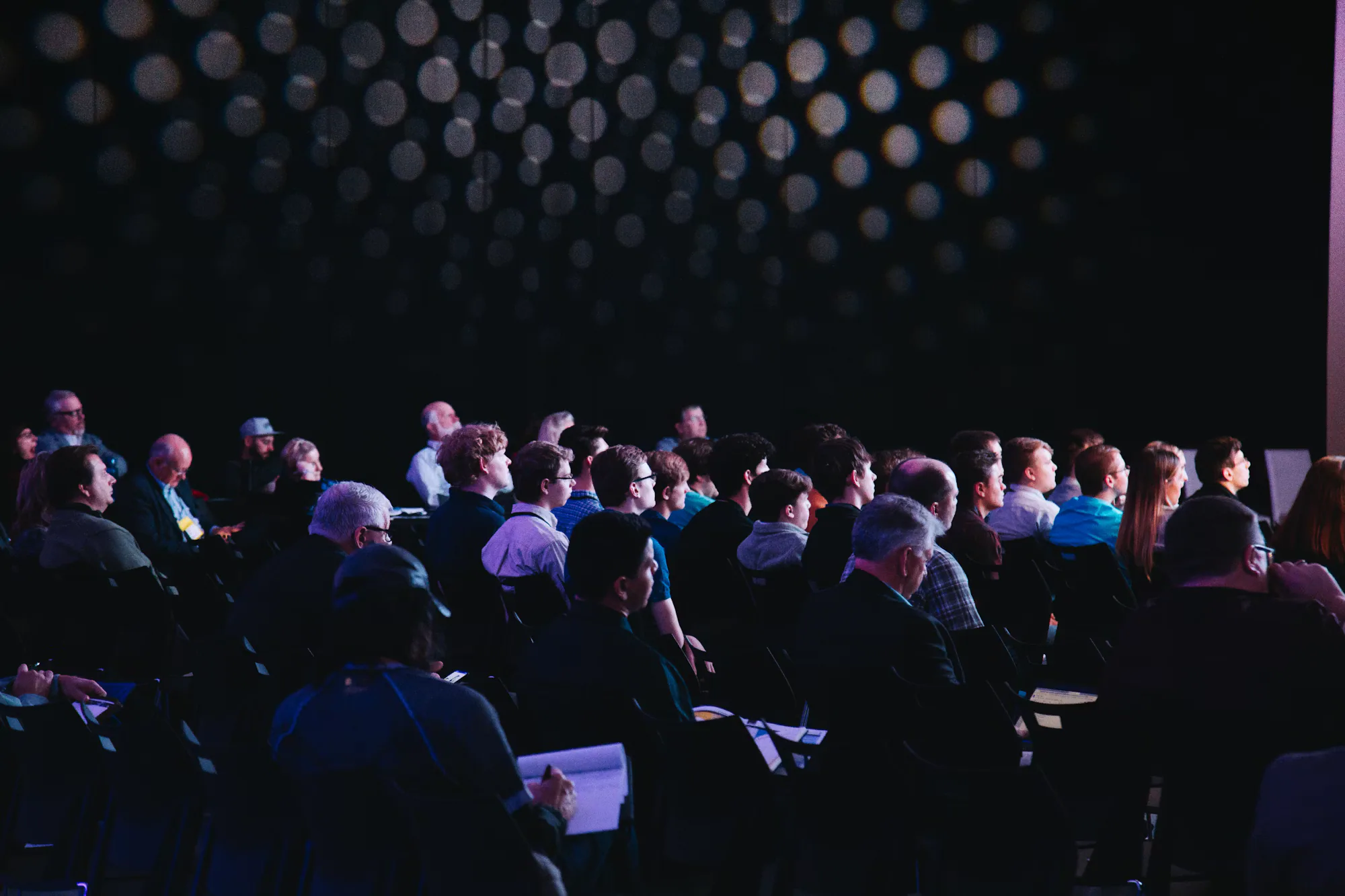 Convention audience seated for a presentation on the main stage