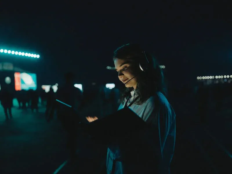 Event coordinator using a headset and tablet during a live event